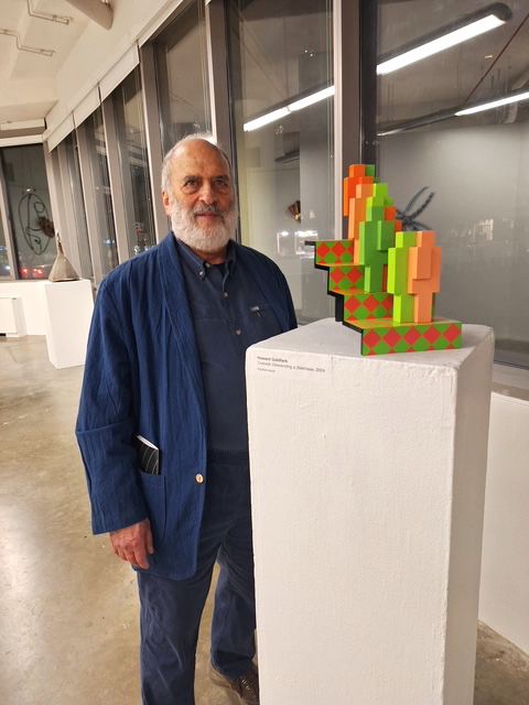 Howard standing with Cuboids Descending a Staircase at Art After Duchamp in 2024.